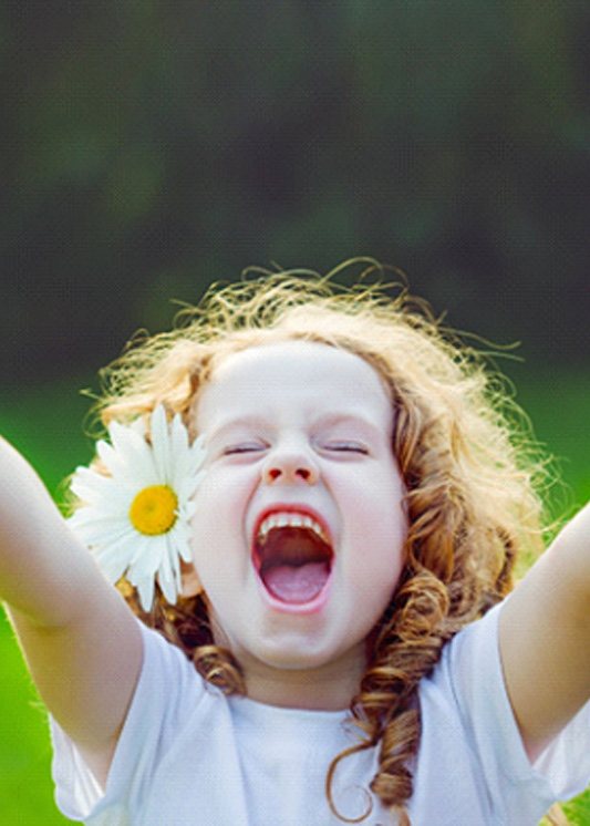 A little girl giving two thumbs up