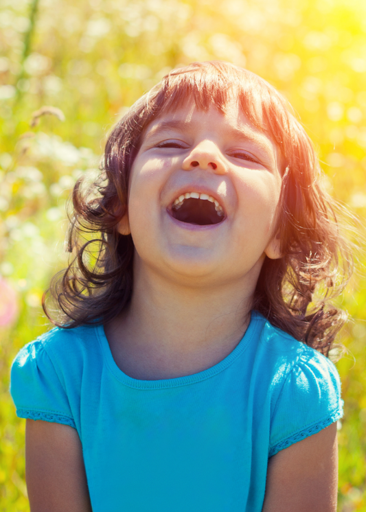 A little girl giving two thumbs up