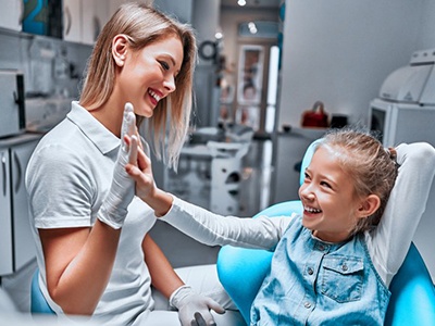 Dentist applying treatment to a patient’s teeth