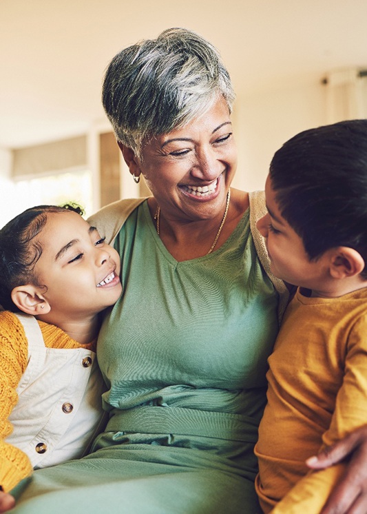 Two happy kids with their grandmother