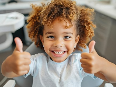 Young girl smiling in the dentist’s chair